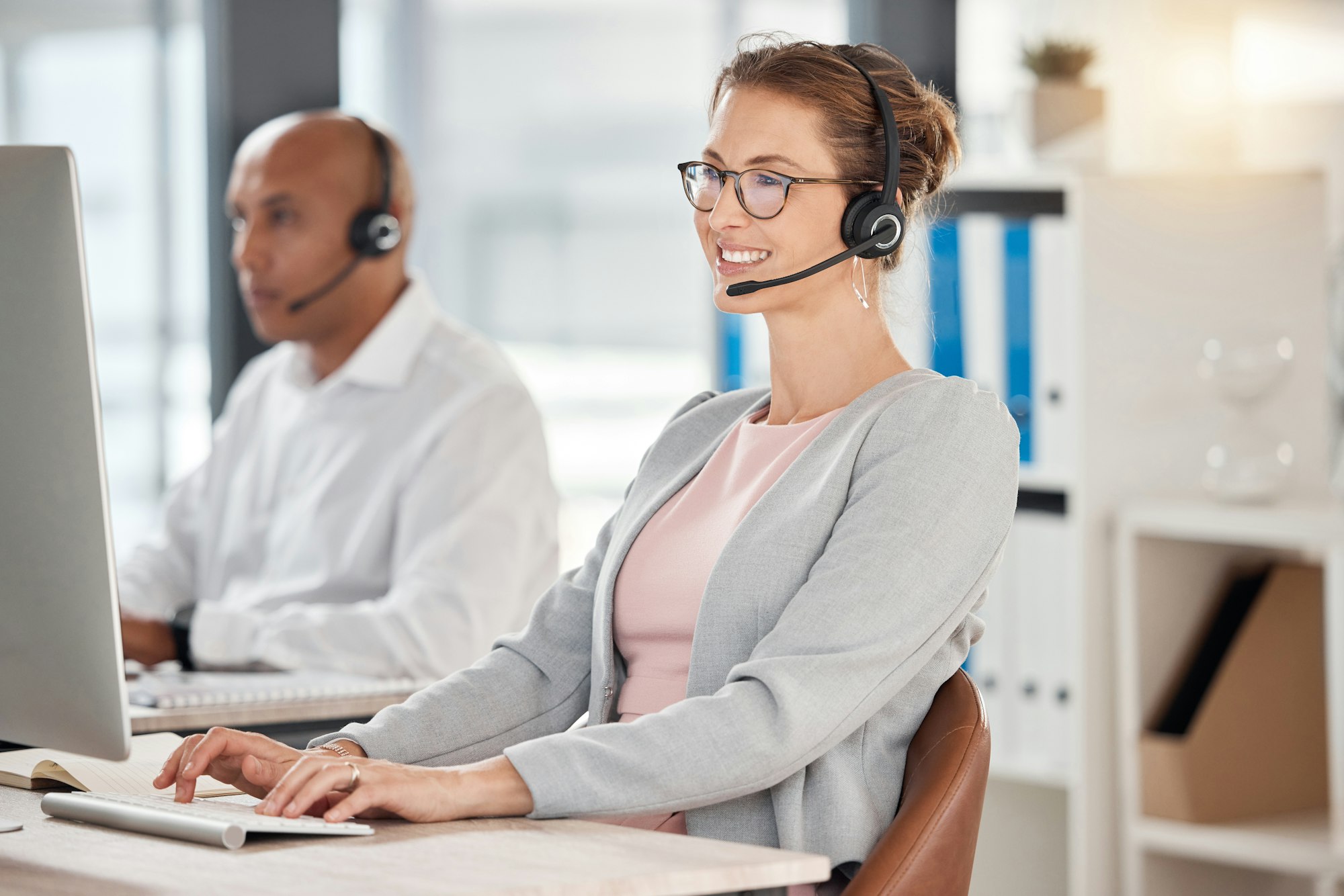 Call center, contact us and worker with a computer for support, help and consulting on the internet